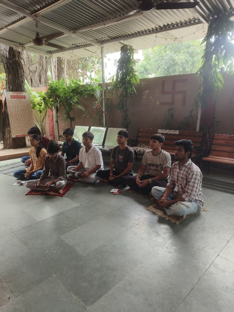 Volunteers in a prayer session during the religious seva and cleanliness program at the temple